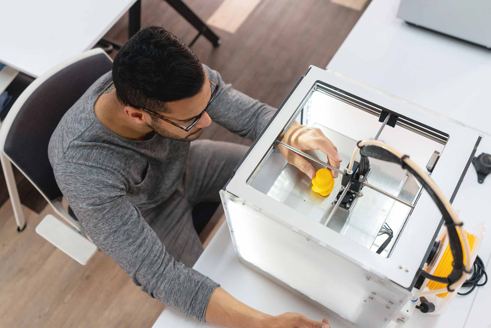 Student working with 3D printer